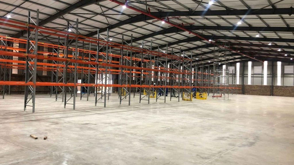 A large warehouse with empty industrial racking systems installed, provided by Duzi Storage Solutions.